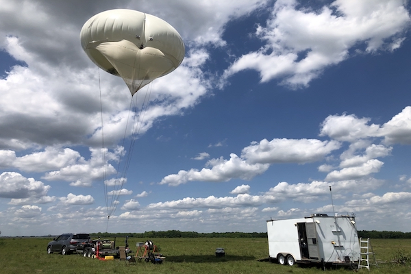 A tethered balloon system is flown at Guy, Texas, as part of the Tracking Aerosol Convection Interactions Experiment (TRACER). The TRACER field campaign collected data on the evolution of convective clouds and the environment at locations around Houston from Oct. 2021 through Sept. 2022. (Photo by Brent Peterson, Sandia National Laboratories. Image courtesy of the U.S. Department of Energy Atmospheric Radiation Measurement (ARM) user facility.)
