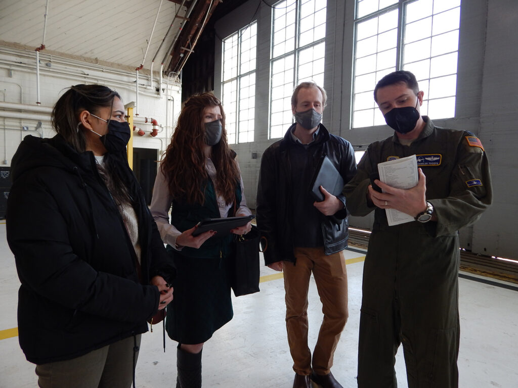 Chandler Thorpe shows graduate students (from left) Mehir Walia, Kelsey Giaimo and Kyle Gero a pre-flight checklist