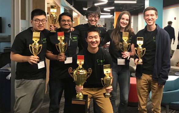 WashU's cybersecurity team poses with their trophies after placing first at the GHECC CyberCup. Submitted photo