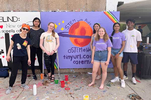 Members of oSTEM paint a mural in the South 40 overpass at a club event during the 2021-22 academic year.