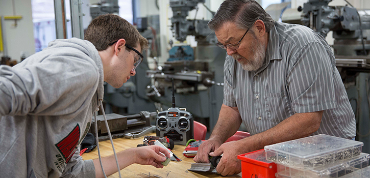 Pat Harkins working in the machine shop with Clayton Keating, an undergraduate Engineering student. Photo by Whitney Curtis